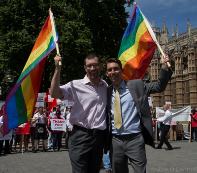 LGBT+ Lib Dems vice-chair Ed Fordham (left) and chair Adrian Trett wave rainbow flags during the Third Lords Reading of the Marriage (Same Sex Couples) Bill